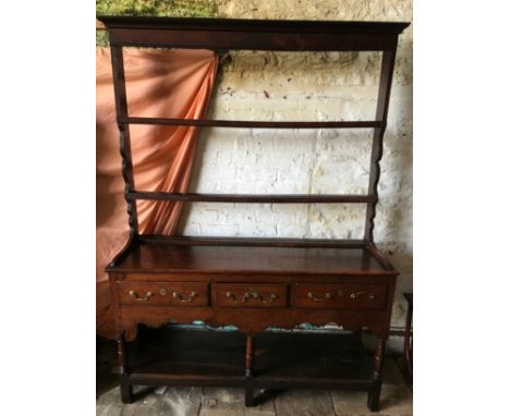 An 18thC oak welsh dresser with 3 drawer base with brass handles, under shelf and open back top shelf. Width 142cms x 44cms d