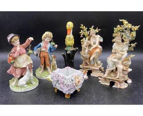 A selection of Continental ceramics to include two pairs of figurines one of ladies with cherubs 22cms h, the other a boy and