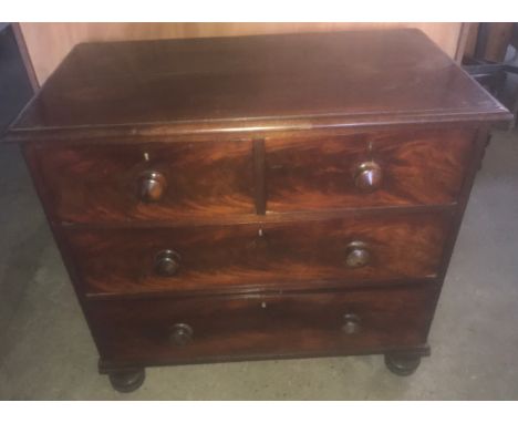 A Victorian mahogany chest of drawers, two short over two long drawers, turned feet, wood handles. 89cms W x 49cms d x 84cms 