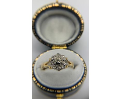 A diamond cluster ring set in 18ct yellow gold with openwork shoulders. Size M. 3.75gms.Condition ReportGood condition.