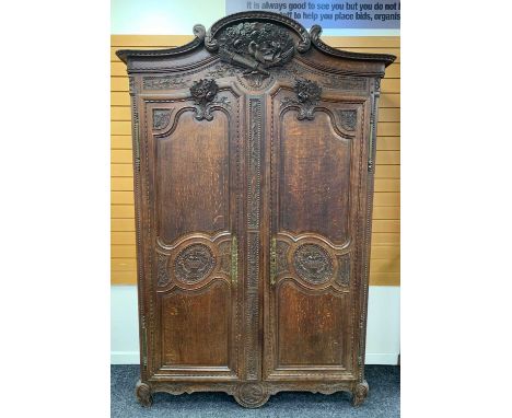 19TH CENTURY PROVINCIAL FRENCH OAK ARMOIRE, probably Normandy, carved C-scroll cornice with high relief love birds, flowers g