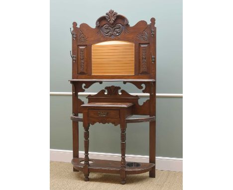 EDWARDIAN OAK HALL STAND, carved surround to the mirror back, above table with glove drawer, gilt metal animal mask hat hooks