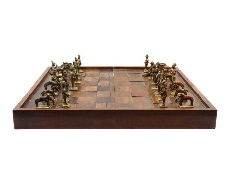 An Anglo-Indian rosewood chess or backgammon board,c.1900, with a full set of sand cast brass and enamelled animalier playing