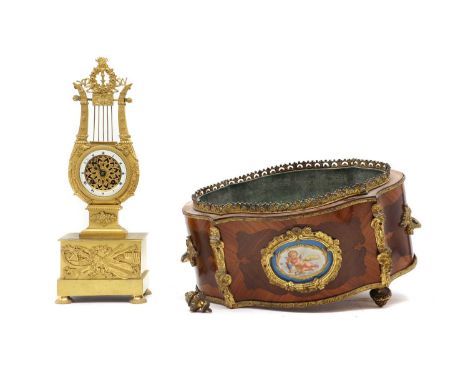 A kingwood jardinière,late 19th century, French, the gilt metal mounts, leading to quarter veneered panels inset with a Sevre