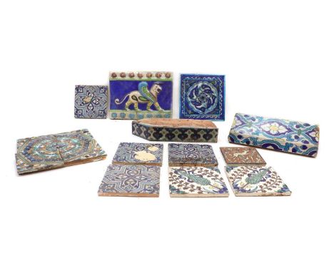 A collection of pottery tiles,predominately in the Iznik palette, to include a shaped architectural example, 30cm high, a sim