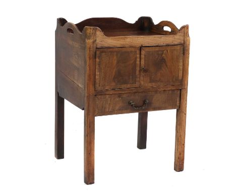 A George III mahogany bedside cabinet,converted commode, with a gallery, over a cupboard and drawer,55cm wide 46cm deep 77cm 