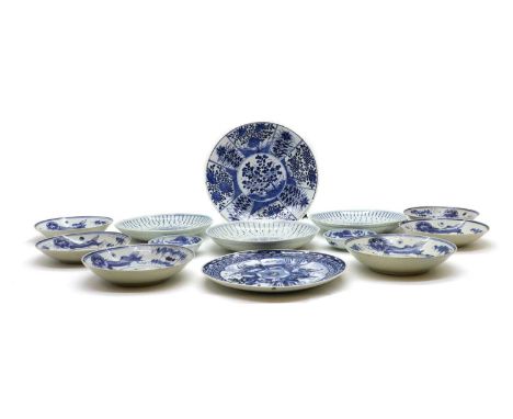A collection of Chinese blue and white plates and saucers, 20th century, painted with figures, flowers, Buddhist lions or dra