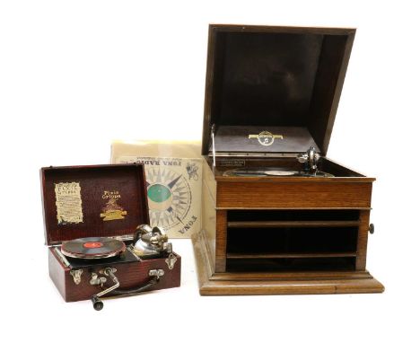 A Pixie Grippa travelling gramophone, cased, with a Mimosa 'Regimental Marches (Devon and Suffolk Regts.) record, 27.5cm wide