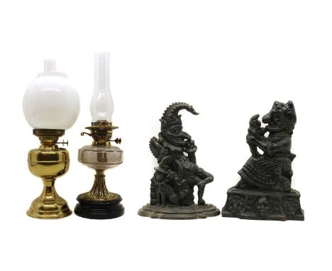 A duplex brass oil lamp,early 20th century, of bulbous form fitted with opaque glass shade and a clear glass chimney,50cm hig