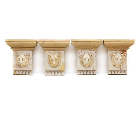 A set of four grey painted wood architectural mounts,late 19th century, each with a gesso moulded Lion mask, 31.5cm wide7.5cm