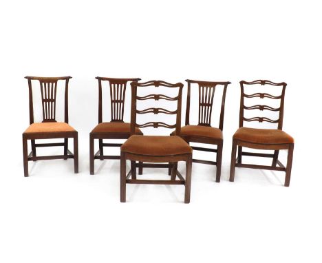 Three Georgian mahogany scroll back dining chairs, with turned and carved leaf details to the top rails, pierced backs, drop 