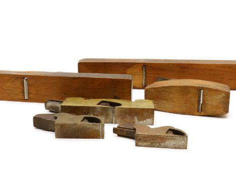 A collection of woodworking planes,comprising a brass and mahogany shoulder plane, two other shoulder planes, and three woode