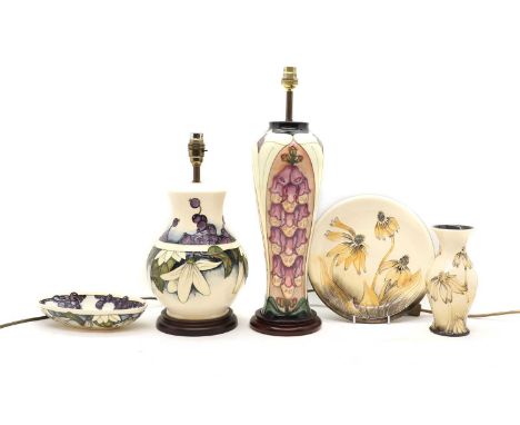 A collection of Moorcroft pottery,comprising a 'Foxglove' pattern vase table lamp, 40cm high to the fitting, a 'Juneberry' pa