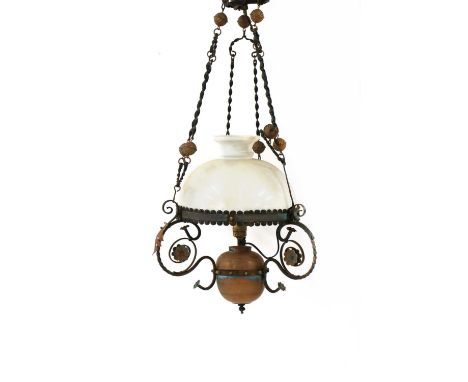 A wrought iron and copper mounted hanging ceiling light,with spiral turned supports, an ovoid reservoir, converted, with a mi