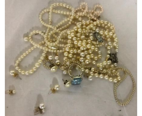 An aquamarine ring; together with four simulated pearl necklaces and simulated pearl earrings