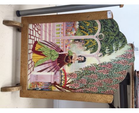 A painted firescreen oil on board of a woman in a garden, signed Bertram Willoughby