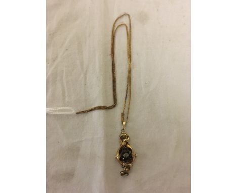 A gold, pearl and garnet pendant
