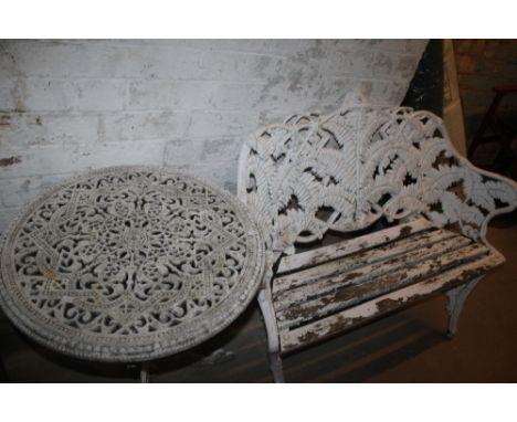 A CAST IRON TWO SEAT DECORATIVE BENCH AND CAST ALUMINIUM GARDEN TABLE