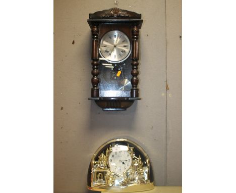 A HANGING WALLCLOCK TOGETHER WITH A DECORATIVE MANTEL CLOCK