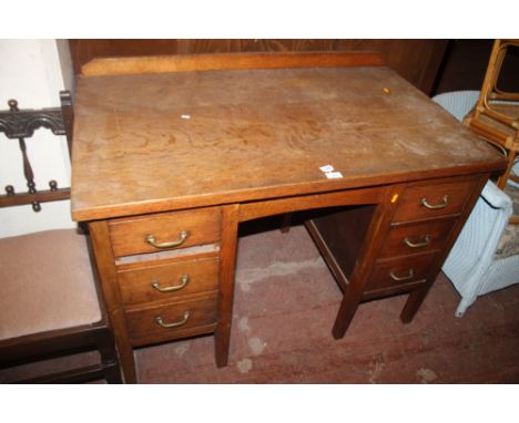 A LIGHT OAK SIX DRAWER DESK