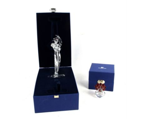 Swarovski limited edition Magic of Dance figures Isadora 2002 (x2) and Antonio 2003, a vase of roses, display stand and unope