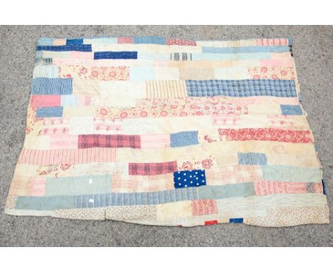 A 1920s patch work quilt with floral panels, interlined, predominately in blue and red 120cm x 176cm a small quantity of off 