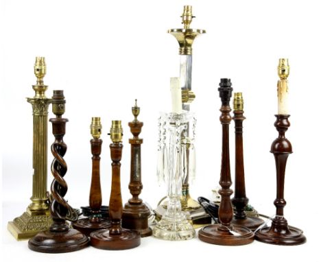 Six turned wood table lamps, thermometer stand, two brass lamps, glass lamp with hanging drops and a decanter lacking stopper