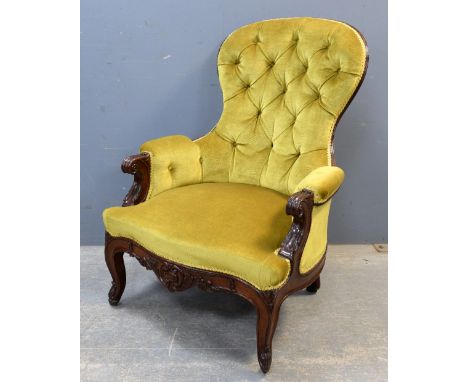 19th Century mahogany button back arm chair on scrolled cabriole legs and castors .     