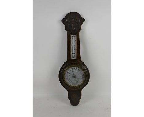 Early 20th century aneroid barometer, with silvered weather dial, mercury thermometer, in oak case .     