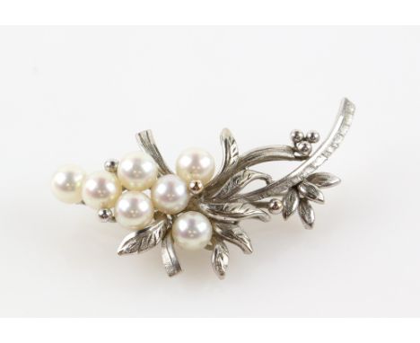 Vintage floral brooch, set with seven cream coloured pearls, 6mm in diameter, mount stamped 14 ct, with pin and roll catch fi