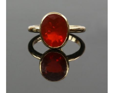 Fire opal ring, rub over set oval cut stone, estimated total weight 2.73 carats, mounted in 9 ct yellow gold, hallmarked Birm