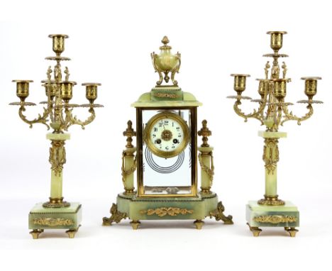 19th century onyx and gilt metal clock garniture, the white enamelled dial with Arabic numerals, twin train movement, flanked