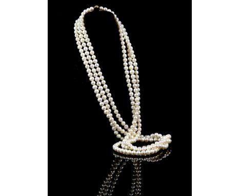 Opera length pearl three strand necklace, white pearls, 8mm in diameter, strung without knots, with a diamond set clasp stamp