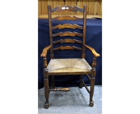 A set of six 19th century style ladder back dining chairs with rush seats, including one carver.     