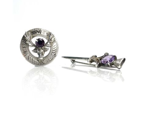 Two Scottish silver brooches set with amethyst, one is annular and with a stag's head, diameter 27mm, the other with thistle 