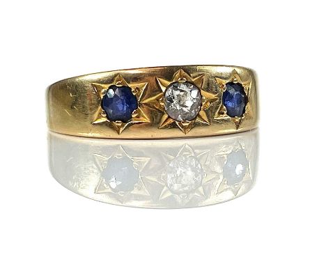 A Victorian diamond and Sapphire three stone gypsy set ring, the central diamond measuring 0.20ct, London 1894, size R/S, wei