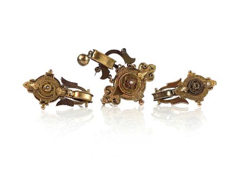 A Victorian gold suite of three brooches, each set with a central seed pearl, the largest brooch width 40mm and with black en