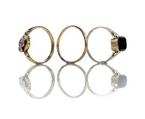 A 22ct gold band ring, 1.2g, together with an 18ct and platinum three stone ring set with chip diamonds, 2.3g and a 9ct blood