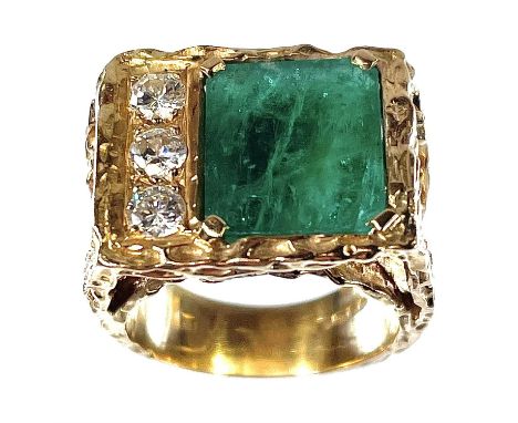 A 1970's 18ct gold emerald and diamond set four stone ring, the emerald measuring 4.8ct approximately, the three diamonds eac