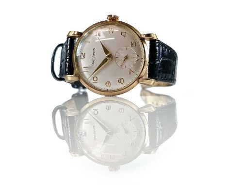 A Garrard 9ct cased gentlemans manual wind wristwatch, the signed 30mm silvered dial with Arabic numerals and subsidery secon