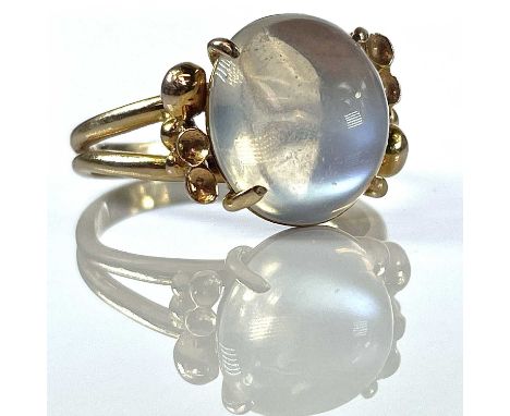 A stylish 14K moonstone set cocktail ring, the cabochon stone measuring 13mm x 12mm, stamped 14K, makers mark CDL, size S/T, 