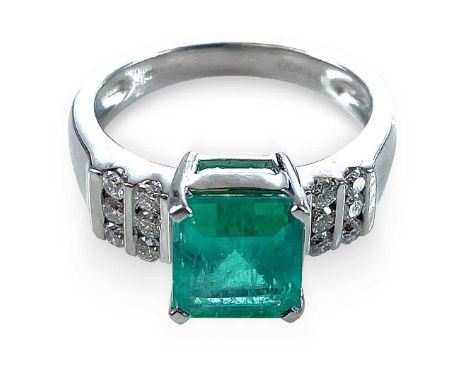 An attractive platinum diamond and emerald cluster ring, the emerald cut stone measuring 2ct approximately, flanked to the sh