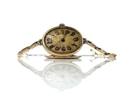 A 1930's 14ct gold ladies manual wind bracelet wristwatch, the oval 18mm gilt dial with Arabic numerals, the case stamped 14k