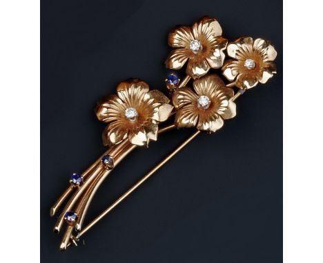 A SAPPHIRE AND DIAMOND SET FLORAL SPRAY BROOCH, each flowerhead centred with a brilliant-cut diamond, to wirework stem highli