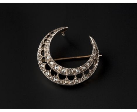 A DIAMOND CRESCENT BROOCH, with pieced scalloped decoration, set with a double row border of graduated rose and lasque-cut di