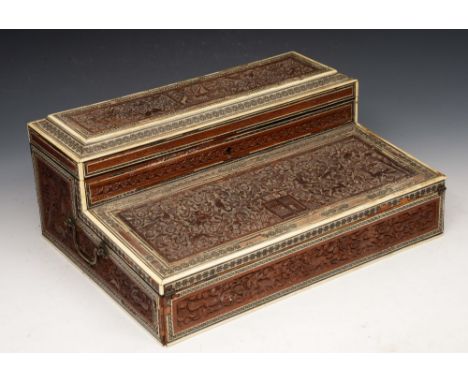 AN INDIAN LATE 19TH CENTURY CARVED SANDALWOOD, BONE AND MOTHER OF PEARL INLAID WRITING BOX, with raised lidded superstructure