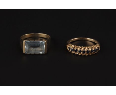 TWO GEM SET RINGS, comprising a sapphire half hoop ring, with pierced setting, 9ct gold mounted, and a synthetic spinel singl