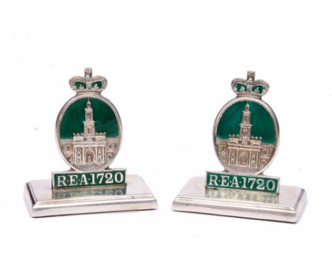 A PAIR OF SILVER AND ENAMEL MENU HOLDERS depicting the Royal Exchange and standing on rectangular bases, 4.5cm high, Birmingh