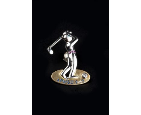 A DIAMOND AND GEM SET NOVELTY GOLFING BROOCH, modelled as a golfer in swing, with circular-cut ruby belt and treated blue dia