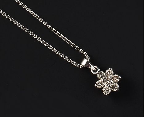 A DIAMOND FLOWERHEAD CLUSTER PENDANT, claw set with seven round brilliant-cut diamonds, 18ct white gold mounted, suspended fr